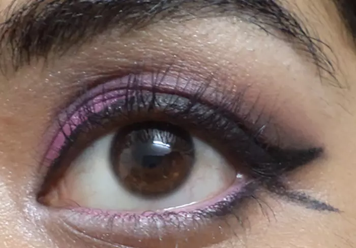 Purple eye makeup step 14 is to highlight your brow bone