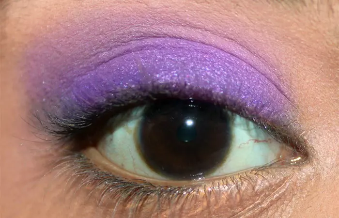 Purple eye makeup step 19 is to apply matte cream eyeshadow to crease area