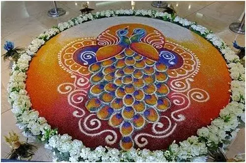 Peacock rangoli design featuring two peacocks and white flower border