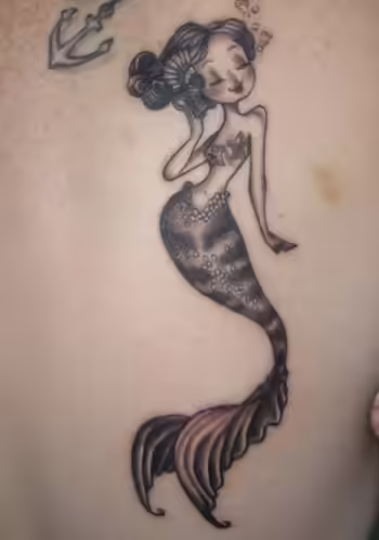 A cartoon mermaid tattoo A cartoon mermaid tattoo