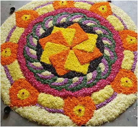 Complex and colorful pookalam design for Onam