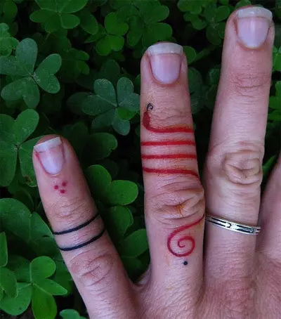miniature snake finger tattoo
