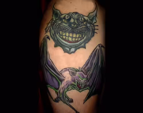 Cheshire Cat with Purple Bat Tattoo Cheshire Cat with Purple Bat Tattoo