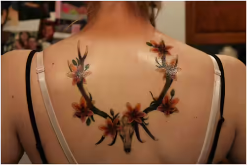 Lily on horns tattoo Lily on horns tattoo