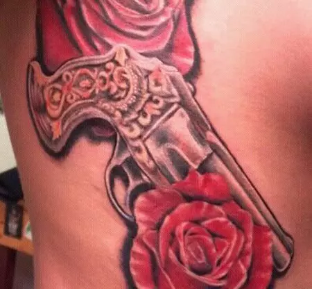 Roses and gun tattoo