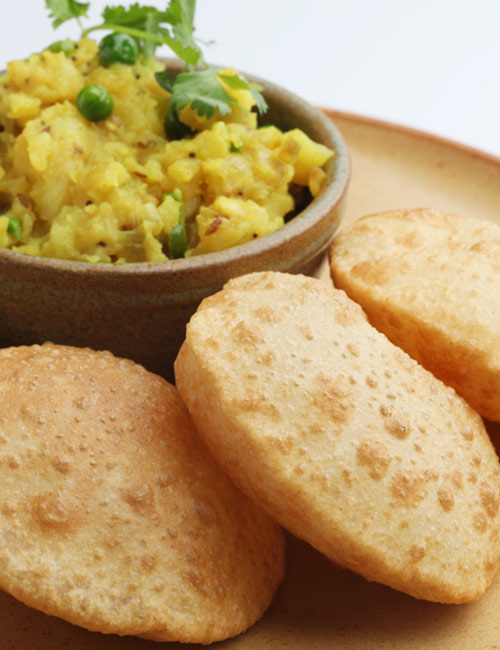 Bengali luchi aloor torkari is an east Indian vegetarian breakfast food Bengali luchi aloor torkari is an east Indian vegetarian breakfast food