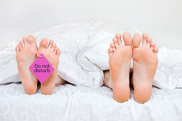 Close-up-of-four-funny-feet-in-a-bed