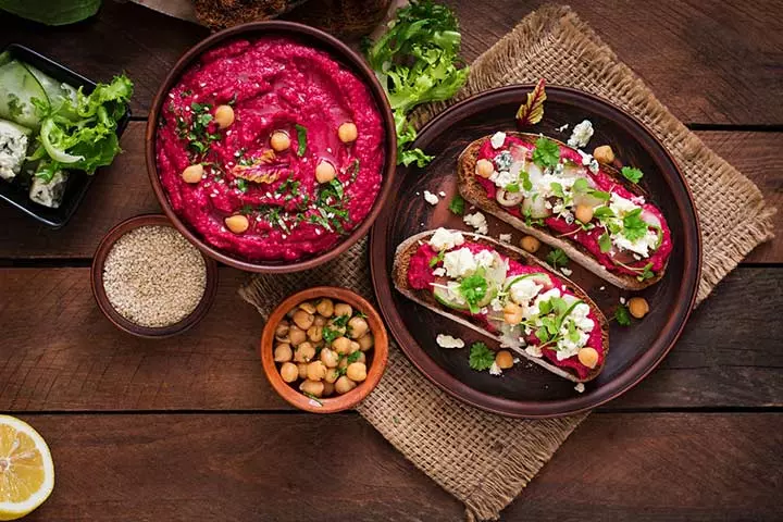 Beetroot hummus toasts with mint and olives