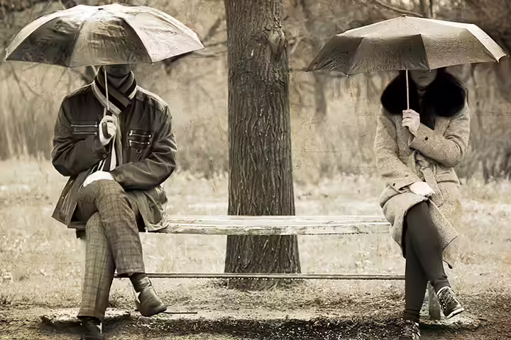 Him And Her And Every Word In Between Two-sitting-at-bench-in-rainy-day