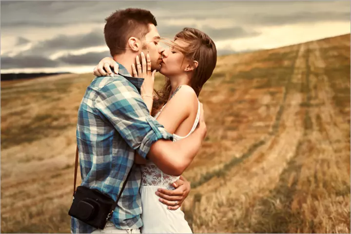 Young-beautiful-sensual-couple-outdoor-kiss-in-windy-weather-in-summer-corn-field