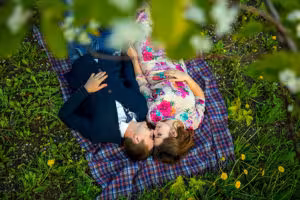 couple-in-love-in-a-blooming-Apple-orchard-lying-on-the-blanket