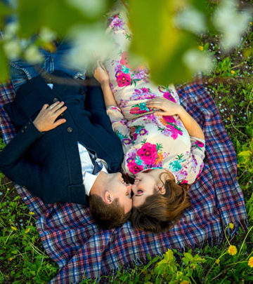 couple-in-love-in-a-blooming-Apple-orchard-lying-on-the-blanket