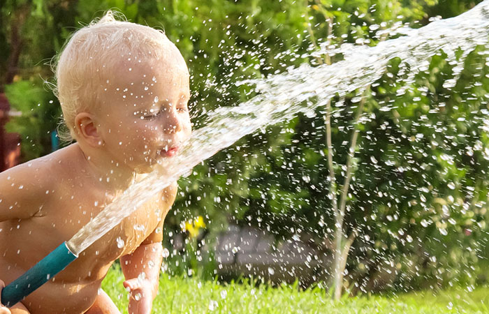 The first time this baby handles a hose