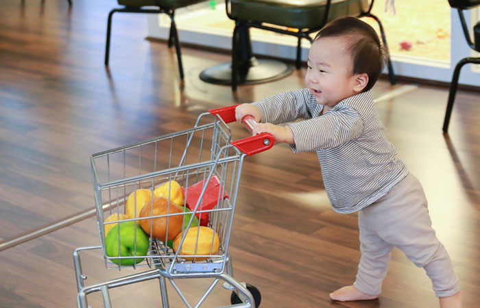 The first time this baby tries to drive the trolley