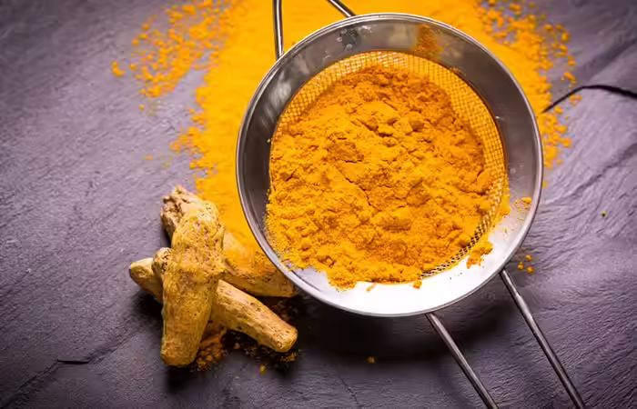 She-Begins-Rubbing-Turmeric-Onto-Her-Cheeks