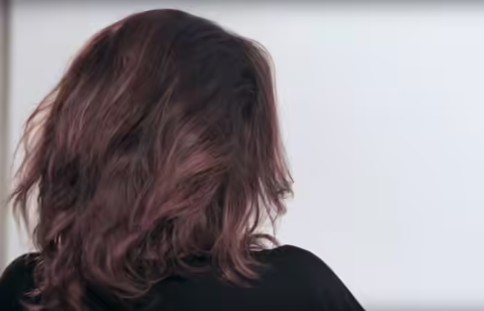 How To Do A Messy Bun - Step 4 Smooth-down-the-hair-on-top-of-the-teased-hair