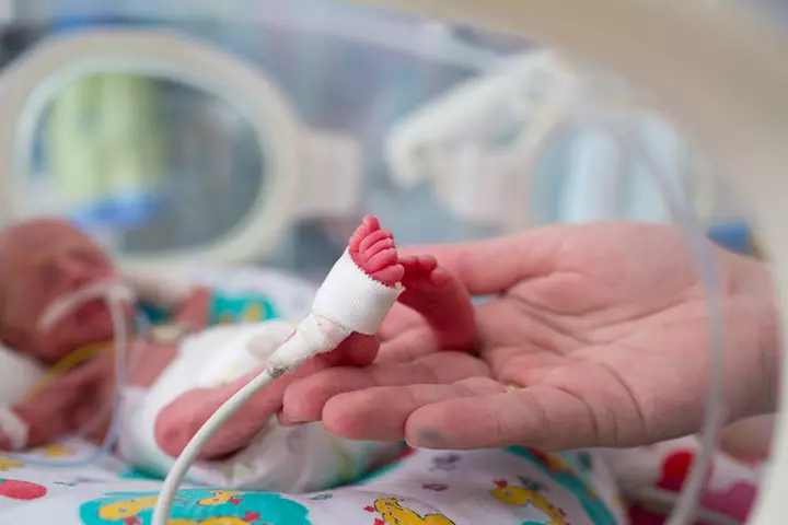 Young Boy Helping Dad Give Skin To Skin Contact To Premature Twins2