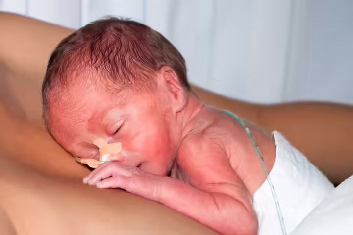 Young Boy Helping Dad Give Skin To Skin Contact To Premature Twins Young Boy Helping Dad Give Skin To Skin Contact To Premature Twins3