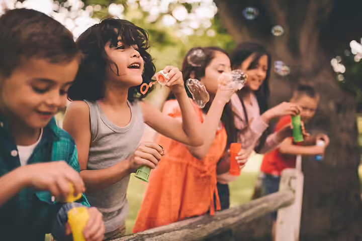 https://www.istockphoto.com/in/photo/little-boy-having-fun-with-friends-in-park-blowing-bubbles-gm517675430-89616245