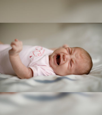 Fussiness is a notable symptom, and burping and tummy time may help provide relief.