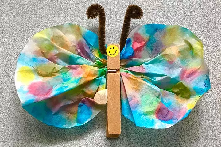 Making a popsicle stick butterfly with pipe cleaner crafts for kids