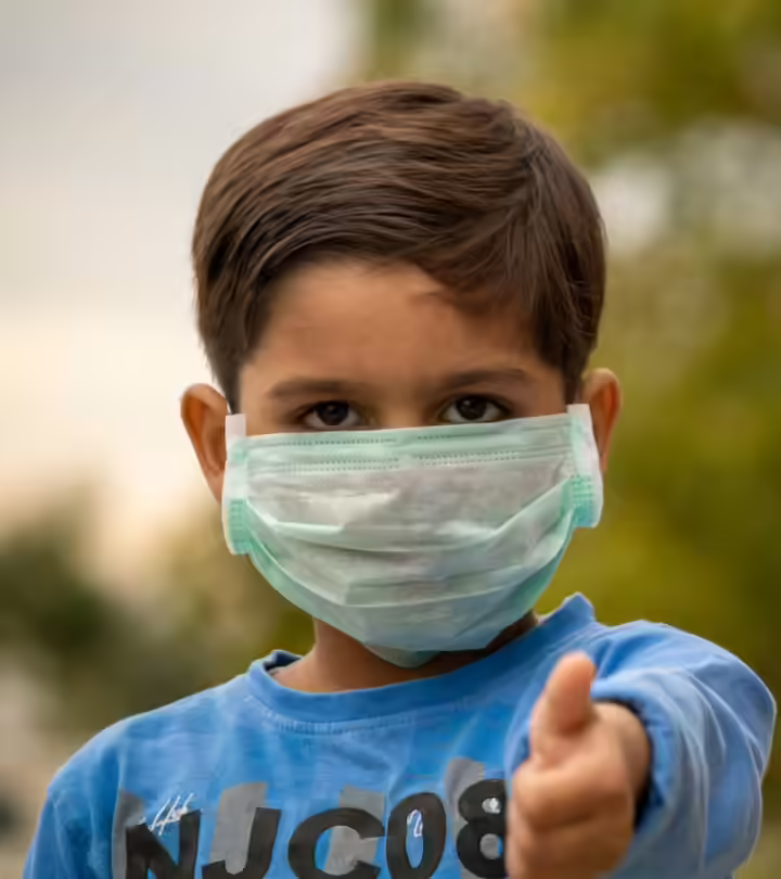 indian-child-mask-showing-thumbs-during