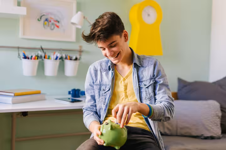 teenage-boy-saving-money-university-605591369