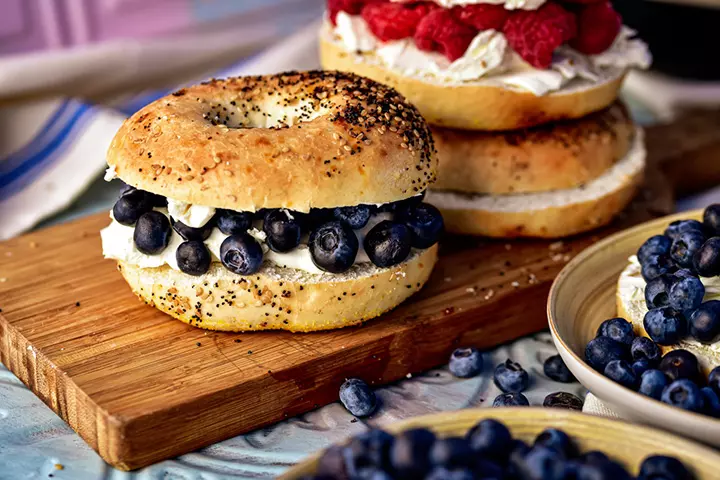 Blueberry cream bagel sandwich with nuts and Greek yogurt, school lunch idea for kids