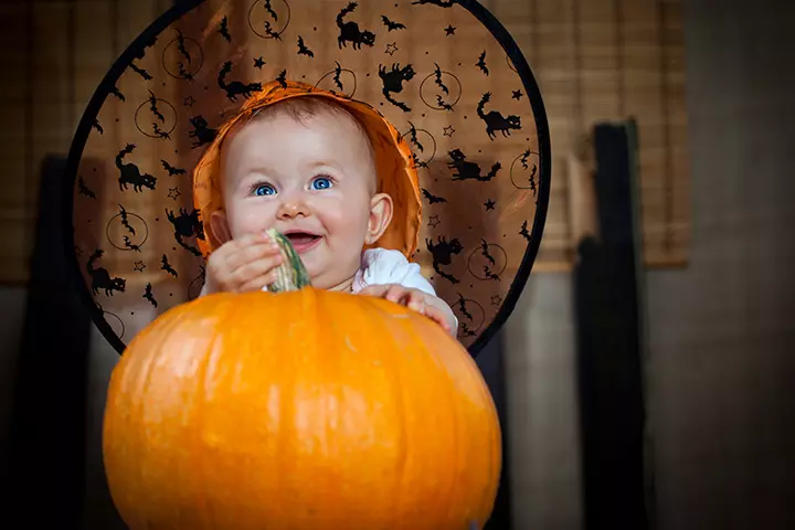 Halloween themed baby in a pumpkin pictures