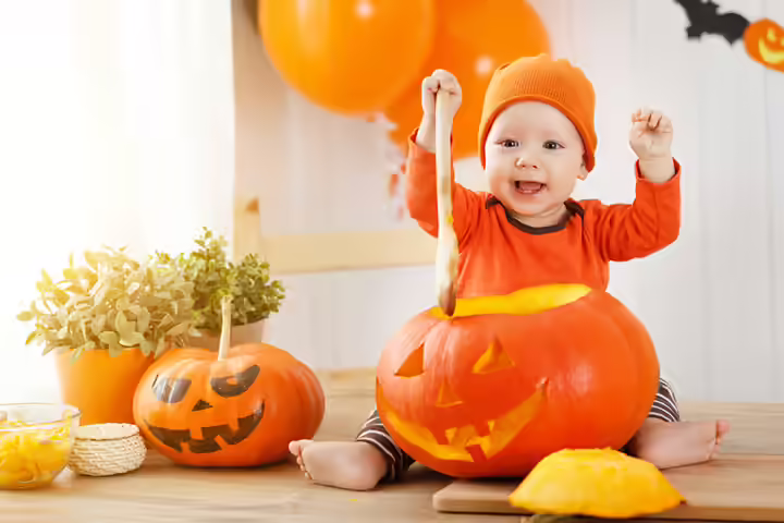 Playing around and laughing baby in a pumpkin pictures Playing around and laughing baby in a pumpkin pictures
