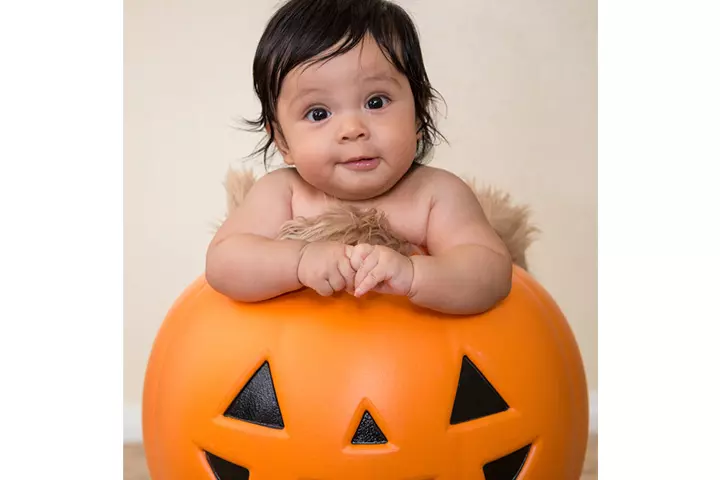 Puzzled baby in a pumpkin pictures