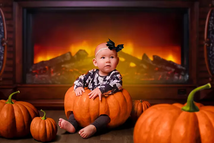 Fireplace in the- background baby in a pumpkin-pictures