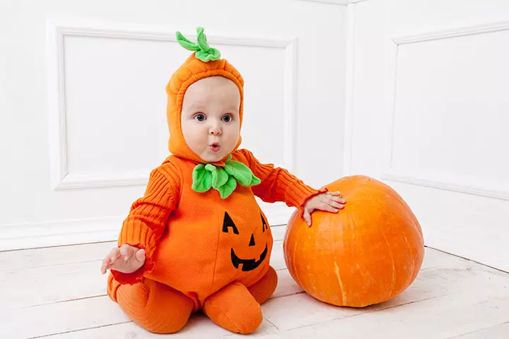 Spooky halloween themed baby in a pumpkin-pictures