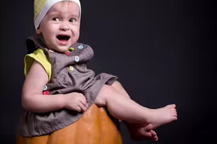 Smiling and happy baby in a pumpkin pictures Smiling and happy baby in a pumpkin pictures