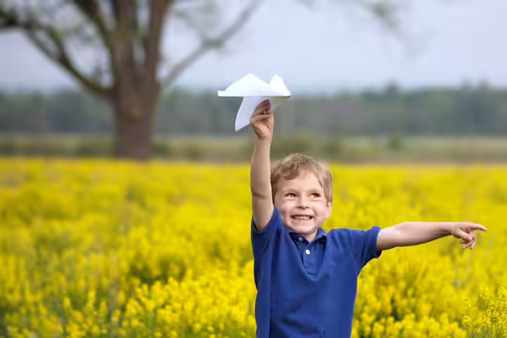 Flying paper airplanes, outdoor activities for babies