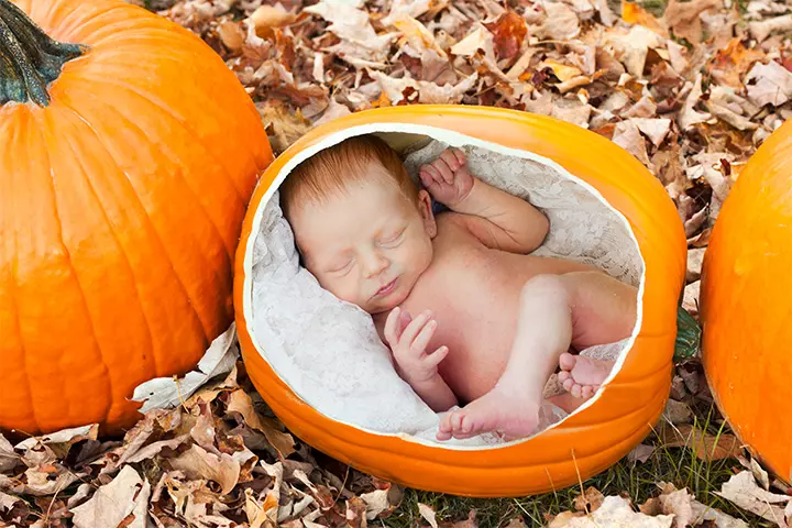 Cozy sleeping baby in a pumpkin pictures