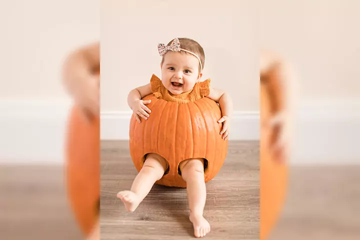 Bow wearing baby in a pumpkin pictures