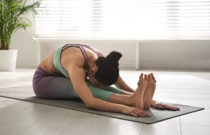 woman-practicing-seated-forward-bend-asana-1615372096