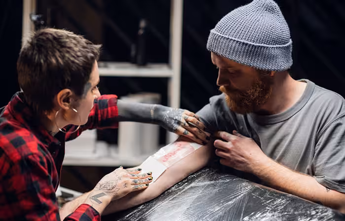 Tattoo artist dressing a fresh tattoo
