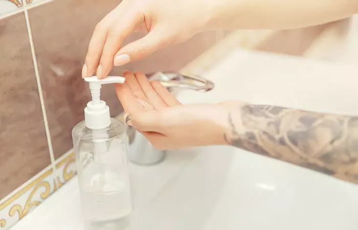 A lady about to wash her arm tattoo