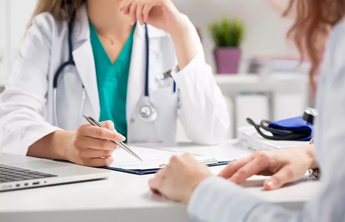 A woman consulting a doctor at a clinic