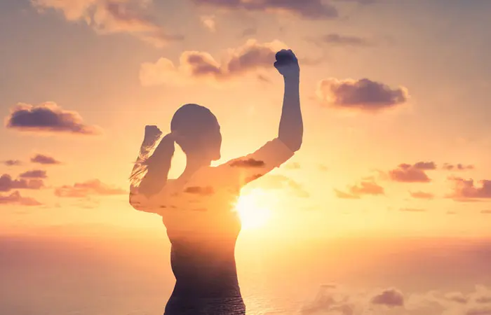 Fearless woman flexing her arms and standing strong