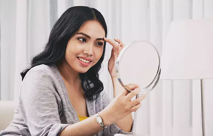 A woman happy with the results of her eyebrow procedure