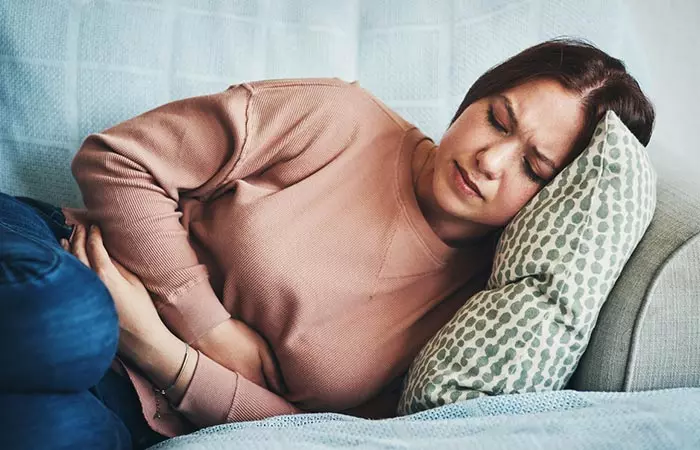 Woman with stomach issues due to persimmon fruits