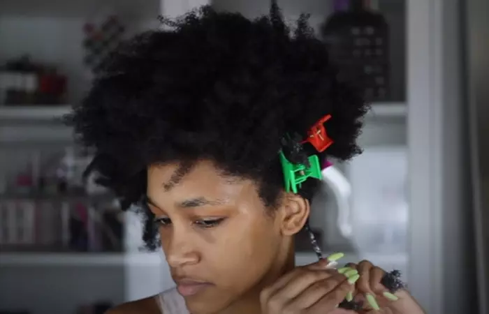 Divide this portion of the hair into two and start twisting them together for perfect twist out on 4C natural hair