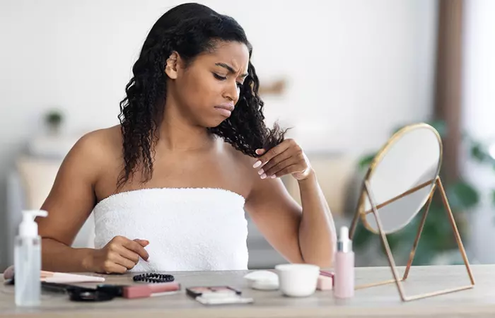 Woman check the hair ends that are dry due to heat damage