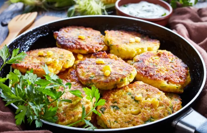 fried-corn-fritters-skillet-yogurt-dipping-1175983036