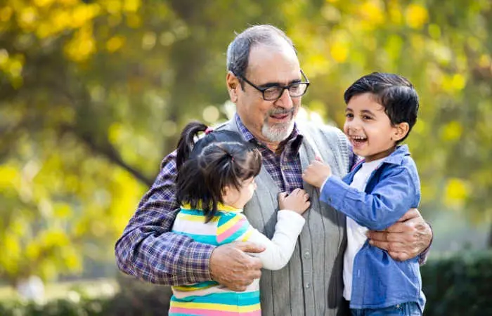 grandchildren-having-fun-with-grandfather-at-park-picture-id1202537140