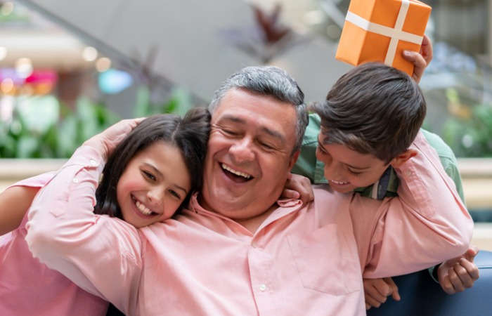 happy-man-celebrating-his-birthday-with-his-grandchildren-and-getting-picture-id1138641511