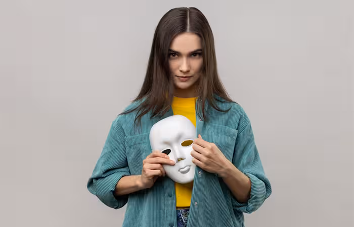 Woman holding a mask to show the concept of change